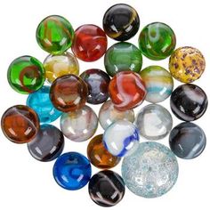 many different colored glass marbles on a white background