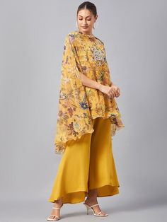 Please check the last image for a detailed size chart This co-ords consists of tunic and palazzos Yellow floral printed tunic, has round neck, flared sleeves Yellow solid mid-rise palazzos have slip-on closure and flared hem Material & Care Polyester Hand Wash/Dry Clean Pattern: Embroidered, Floral Print Style: Co-ord Set, Wedding Guest Outfit Dispatch within 7 days Flared Palazzo, Kaftan Tunic, Indian Suits, Co Ords, Print Style, Co Ord Set, Guest Outfit, Western Outfits, Co Ord