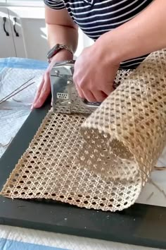 a person is making something out of burlap on a cutting board in the kitchen