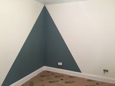 an empty room with a wall painted green and white