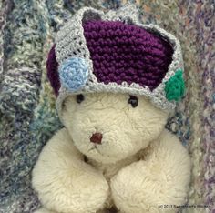 a white teddy bear wearing a crocheted hat