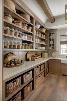 a kitchen filled with lots of wooden shelves