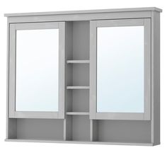 a white cabinet with two mirrors and shelves on it's sides, against a white background