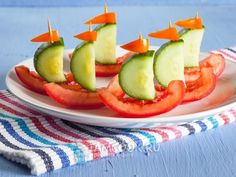 a white plate topped with cucumber and tomato boats