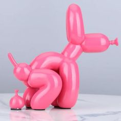 a pink balloon dog laying on its back