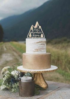 a wedding cake sitting on top of a wooden table