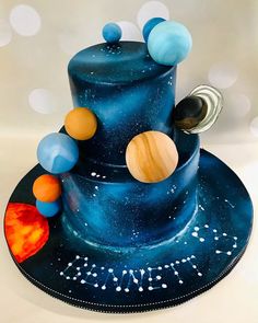 a blue cake with planets and stars on it