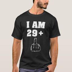 a man wearing a black t - shirt with the words i am 29 plus on it