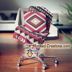 a chair with a blanket on top of it sitting on a wooden floor next to a potted plant