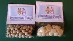 two bags of snowman poop candy on a green table with white candies