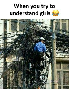 an electrician is working on wires in the city, with caption that reads, when you try to understand what kind of power lines they are