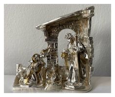 a silver figurine depicting the birth of jesus