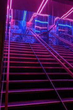 the stairs are lit up with neon lights