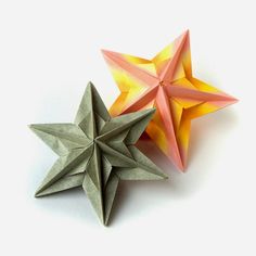 two folded origami stars sitting next to each other