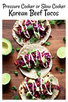 three beef tacos on tortillas topped with cole slaw and avocado