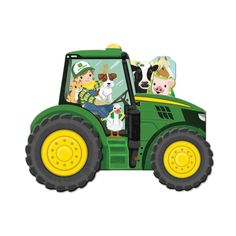 a green tractor with dogs driving down the road on it's front end and side