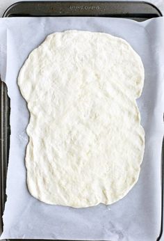 an uncooked tortilla on a baking sheet ready to go into the oven