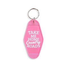 a pink keychain with the words take me home country roads printed on it