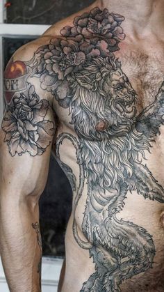 a shirtless man with tattoos on his chest