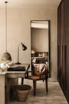 a room with a desk, chair and lamp on it's side in front of a mirror