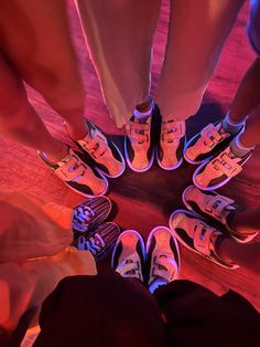 several people standing in a circle with their feet together