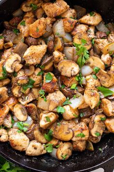 chicken and mushrooms in a skillet with parsley garnish on the side