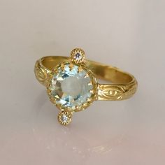 Aquamarine Solitaire Ring. Gemstone of breath, Confidence, clarity and Love. * Pristine Brazilian Rose Cut Aquamarine * 18k Solid Gold * 2 VS SI 0.01ct Natural Brilliant Ethically sourced Diamonds * Sizing included from 4us to 7.5us *Free worldwide Shipping Custom orders Welcomed! For more rings: https://www.etsy.com/shop/templejewelsibiza/items?section_id=21449468 To my shop: https://www.etsy.com/shop/templejewelsibiza Anniversary Fine Jewelry Topaz Ring With Rose Cut Diamonds, Anniversary Topaz Ring With Rose Cut Diamonds, 14k Gold Engraved Ring With Rose Cut Diamonds, Heirloom Rings With Diamond Accents And White Topaz, Heirloom Style Rings With Diamond Accents And White Topaz, Heirloom White Topaz Ring With Diamond Accents, Heirloom Style White Topaz Ring With Diamond Accents, Rings With Rose Cut Diamonds And Blue Topaz, Fine Jewelry Blue Topaz Rings With Rose Cut Diamonds