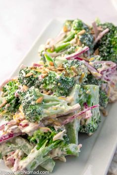 a white plate topped with broccoli and salad