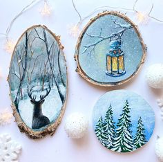 three handmade christmas ornaments on a white surface with snowflakes and pine trees