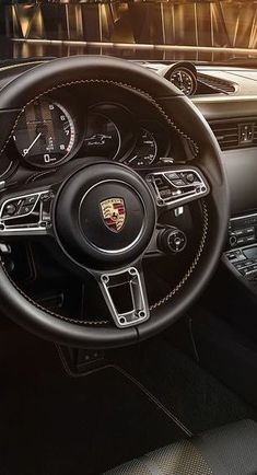 the interior of a porsche car with black leather trims and gauges on display