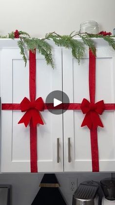 the kitchen is decorated for christmas with red bows