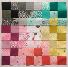 a patchwork quilt with different colors and patterns