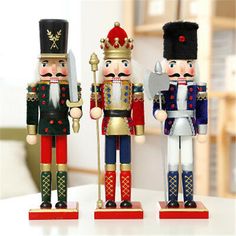 three nutcracker figurines sitting on top of a table