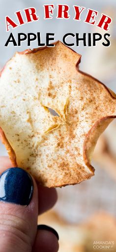 an apple chip being held up to the camera with text overlay that reads air fryer apple chips