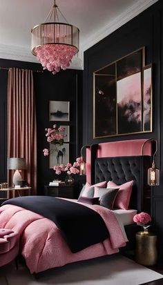 a bedroom with black walls, pink bedding and chandelier hanging from the ceiling