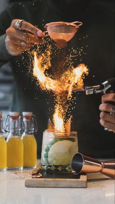 a person pouring liquid into a jar on top of a counter