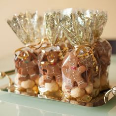 three bags filled with candy sitting on top of a green tray next to a keychain