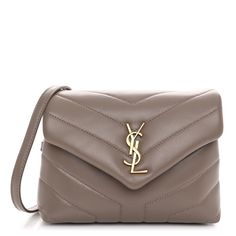 This is an authentic SAINT LAURENT Calfskin Y Quilted Monogram Toy Loulou Crossbody Bag in Greyish Brown. This elegant shoulder bag is crafted of chic chevron quilted calfskin leather in beige. The bag features a leather shoulder strap and gold hardware. The front flap features a prominent gold YSL monogram detail and opens to a partitioned black fabric interior with zipper and patch pockets. Greyish Brown, Yves Saint Laurent Bags, Chevron Quilt, Saint Laurent Bag, Wallet Chain, Quilted Leather, Black Cross Body Bag, Bag Straps, Black Fabric