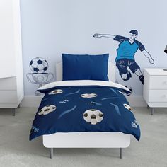 a bed room with a soccer themed comforter