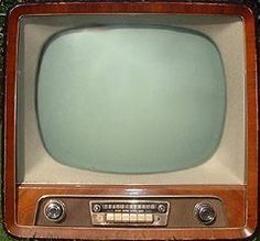 an old fashioned television sitting on the ground