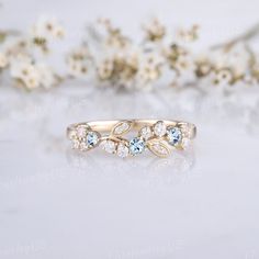 a close up of a ring with flowers in the background