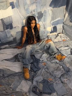 a woman sitting on top of a pile of jeans