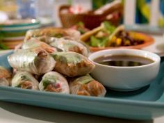 a plate full of food with dipping sauce