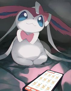 a phone sitting on top of a bed next to a pokemon stuffed animal with pink hair