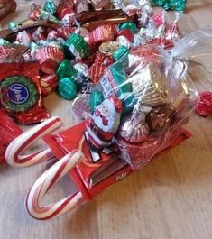 a pile of assorted candy on top of a wooden table