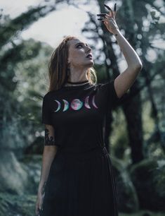 Glitch moon graphic on super-soft, modern fit unisex tshirt in Black. Will become your next wardrobe staple as it goes great with skirts or oversized over leggings. Perfect for yourself or as a gift for your favorite witchy human. Plus sizes available for a roomy fit. Size up for an oversized aesthetic look, size chart found in images. + Printed on Bella + Canvas 3001 unisex tshirt + Retail fit + 100% Soft cotton + Light fabric + Tear away label + Runs true to size. Size chart found in images. T Black Moon Print Graphic Tee, Black Graphic Tee With Moon Print, Black Short Sleeve T-shirt With Moon Print, Mystical Short Sleeve Top With Graphic Print, Mystical Graphic Print Short Sleeve Top, Black Moon Print Top For Festivals, Mystical Black Top With Graphic Print, Mystical Black Tops With Graphic Print, Festival T-shirt With Moon Print And Short Sleeves