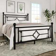 a black metal bed frame in a bedroom