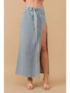 Add a touch of sass to your wardrobe with our Cut Out Belted Rhinestone Fringe Maxi Denim Skirt. This unique piece features a playful fringe and sparkling rhinestones, perfect for adding a bit of fun to your outfit. The cut-out design and belted waist add an edgy twist, making it a must-have for any fashionista. Style this skirt in a western style by pairing it with our cactus jack crop top that is perfect to accentuate your waist, finish your western outfit off with our adel boots that go with absolutely everything. This skirt is a true to size fit, since it does not have any stretch and you carry weight on your bottom half you may need to size up maybe twice. Product Details: -Pockets -Belt with rhinestone included -High leg cut out -Zero Stretch -Maxi length -Rhinestone fringe Washing i Party Denim Bottoms With Fringe, Spring Skirt With Beaded Fringe, Spring Fitted Skirt With Rhinestone Fringe, Fitted Skirt With Rhinestone Fringe For Spring, Spring Skirt With Rhinestone Fringe, Chic Bottoms With Rhinestone Fringe For Spring, Chic Spring Bottoms With Rhinestone Fringe, Sequin Shirt Dress, Maxi Denim Skirt