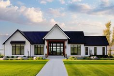 a large white house sitting on top of a lush green field