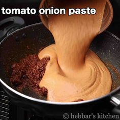 a wooden spoon mixing some food in a pot with the words tomato onion paste on it